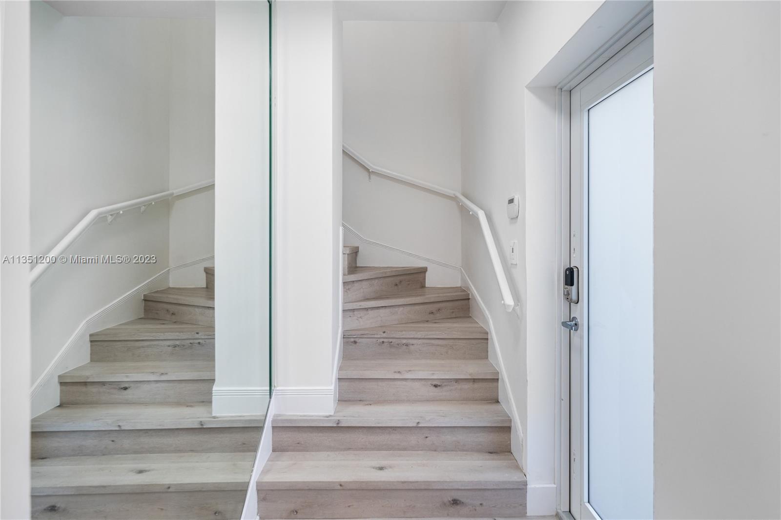 5512 La Gorce Drive Miami Beach, FL 33140 - Photo 6 of 35 a view of staircase with white walls and white walls