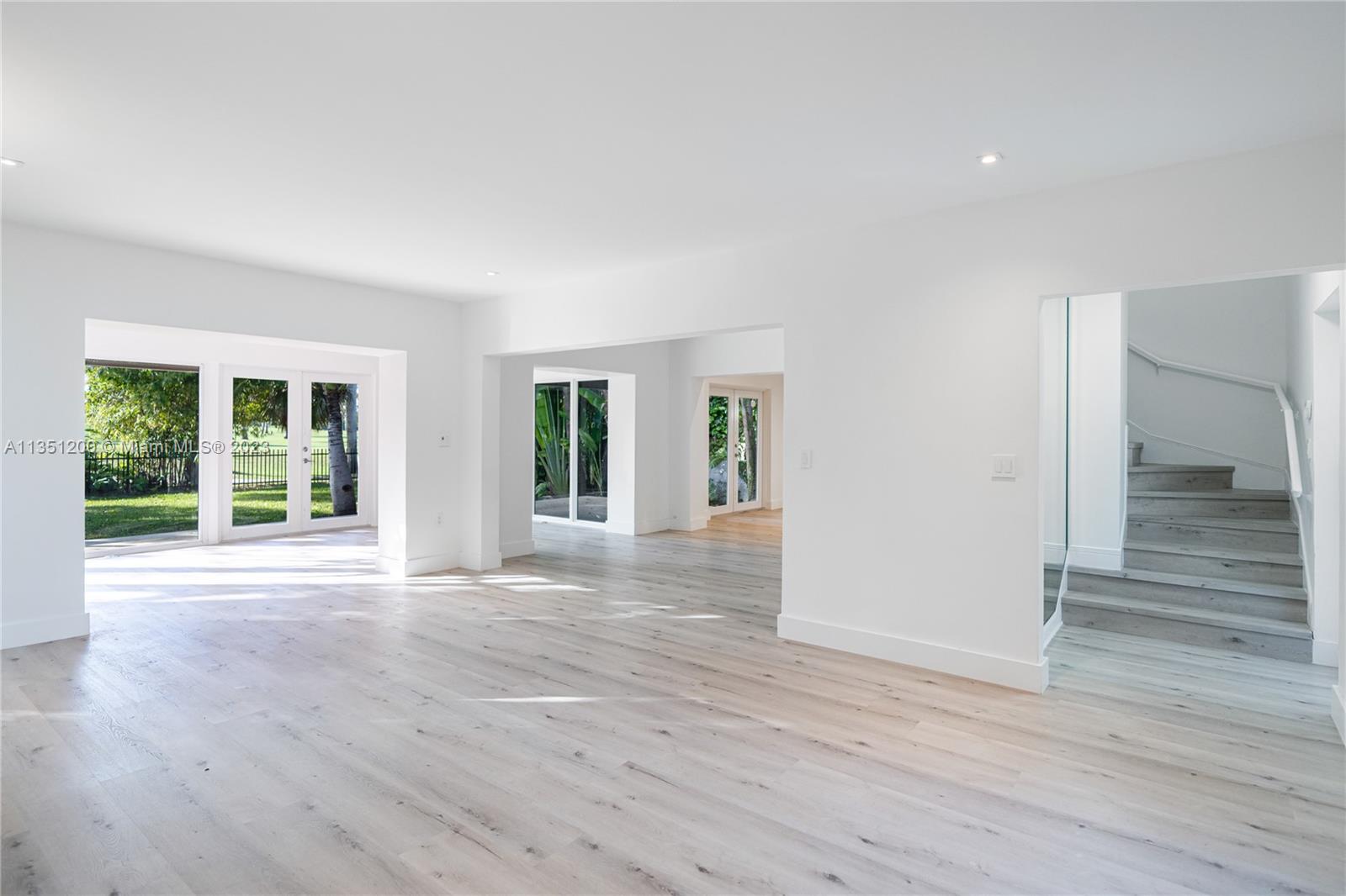 5512 La Gorce Drive Miami Beach, FL 33140 - Photo 7 of 35 a view of an empty room with wooden floor and a window
