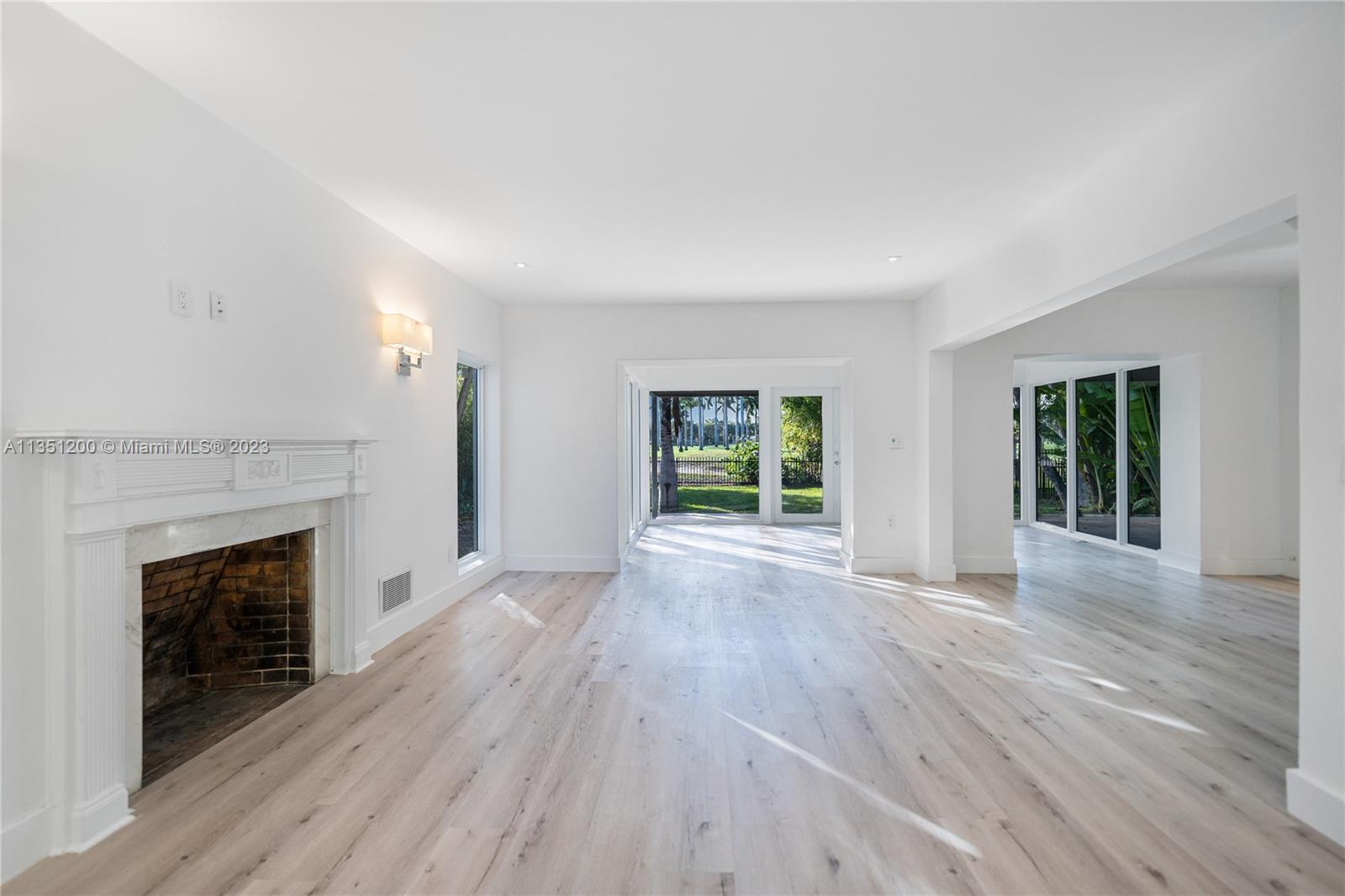 5512 La Gorce Drive Miami Beach, FL 33140 - Photo 8 of 35 an empty room with wooden floor and fireplace