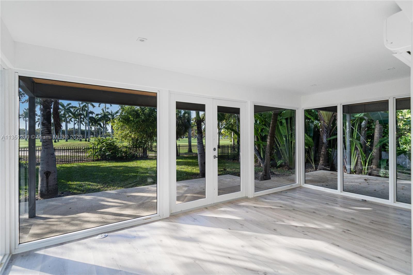 5512 La Gorce Drive Miami Beach, FL 33140 - Photo 10 of 35 a view of a room with a large window and yard