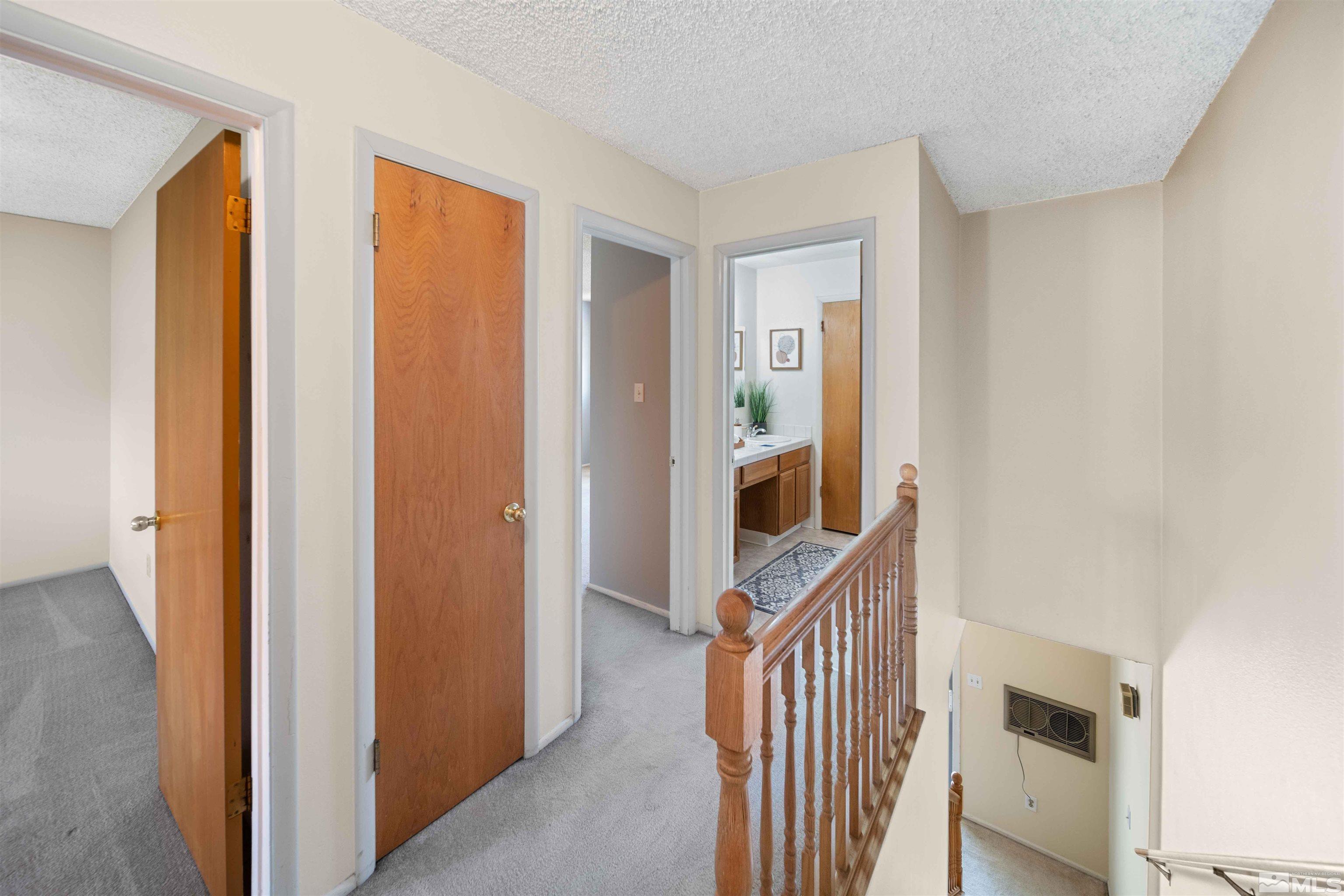 426 Smithridge Drive Reno, NV 89502 - Photo 11 of 20 a view of hallway with stairs and wooden floor