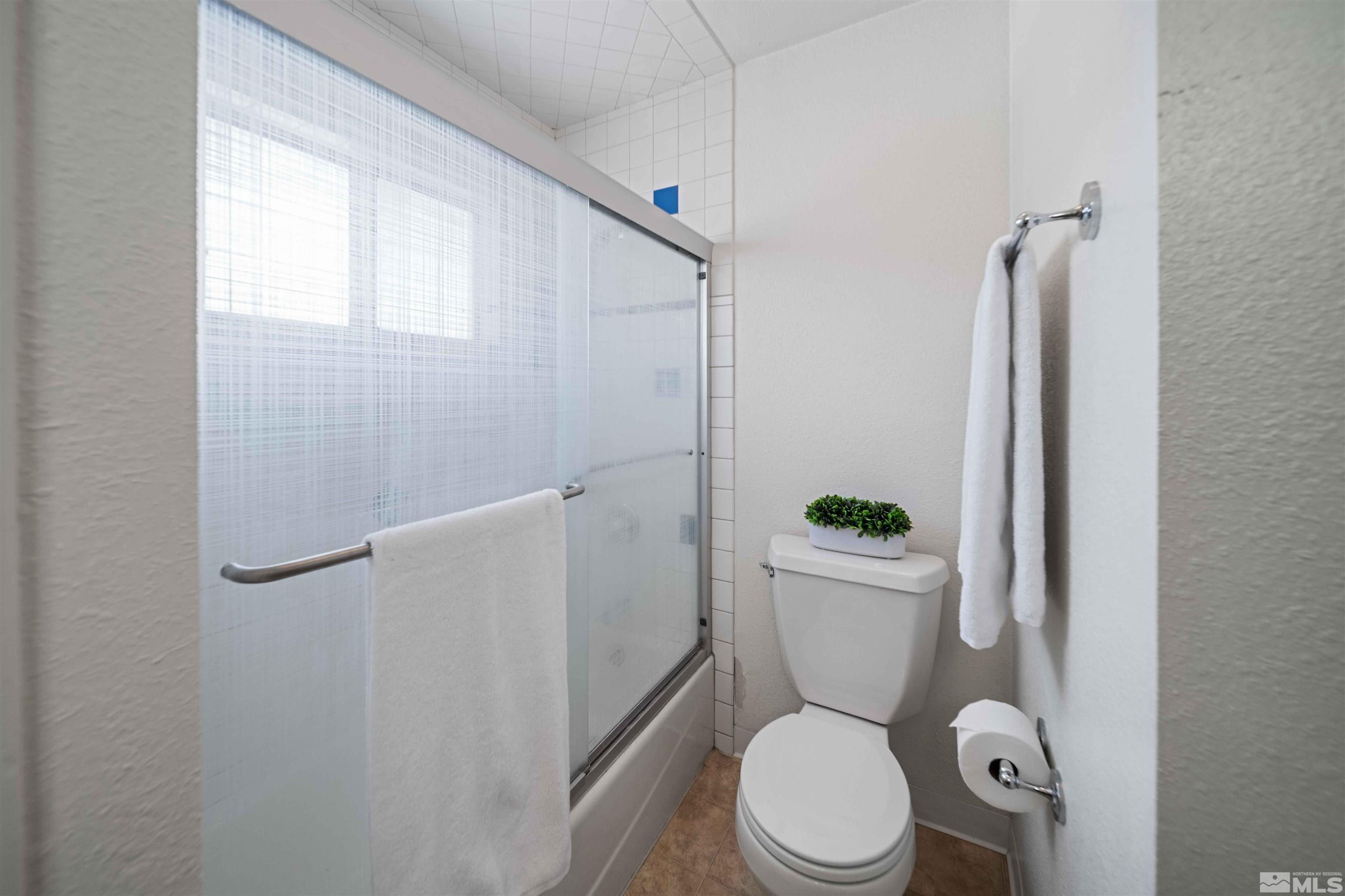 426 Smithridge Drive Reno, NV 89502 - Photo 14 of 20 a white toilet sitting next to a bathroom sink and a shower