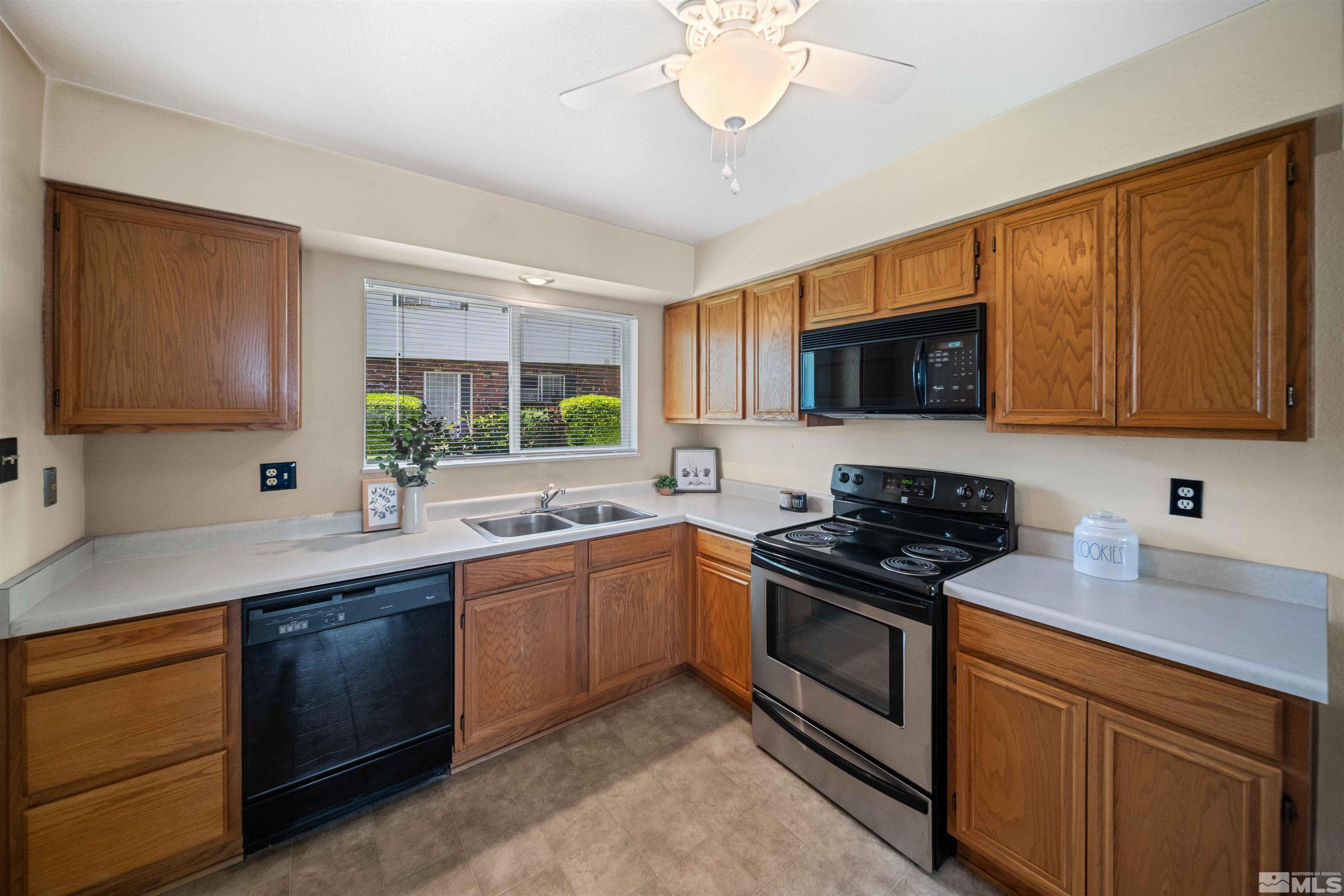426 Smithridge Drive Reno, NV 89502 - Photo 3 of 20 a kitchen with stainless steel appliances granite countertop a sink and stove top oven