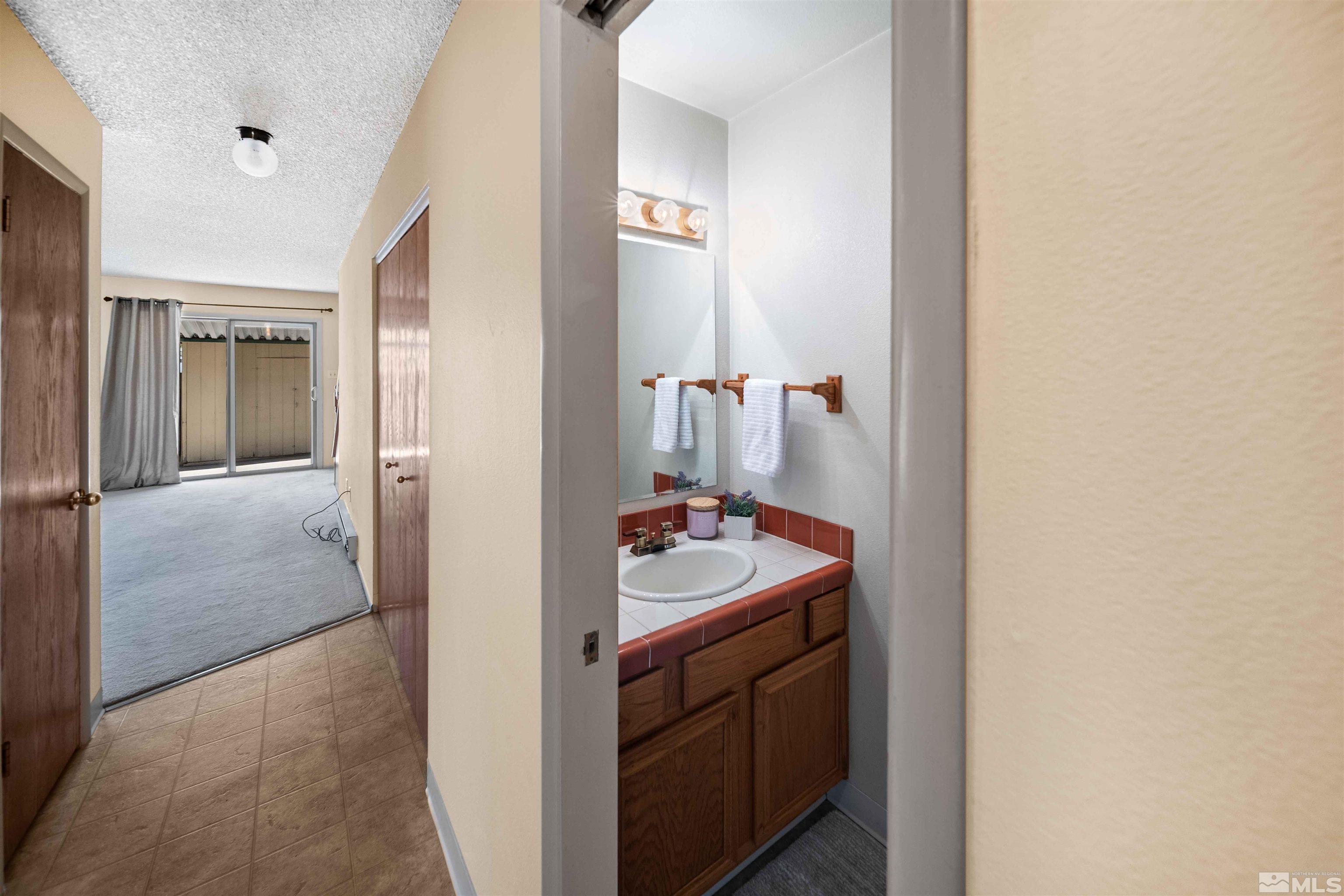 426 Smithridge Drive Reno, NV 89502 - Photo 6 of 20 a bathroom with a sink and mirror