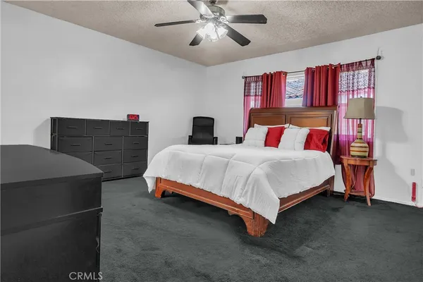a bedroom with a bed and dresser