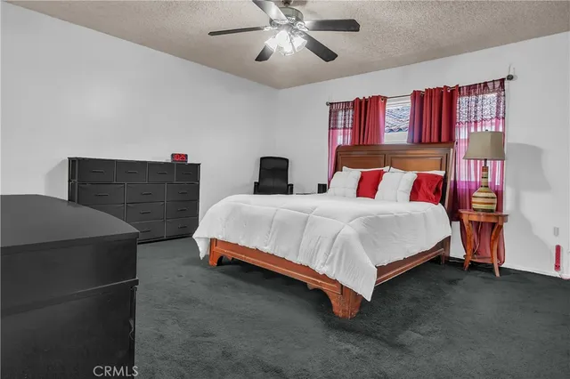 a bedroom with a bed and dresser