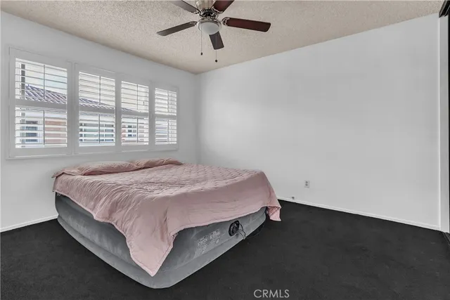 a bed sitting in a bedroom next to a window