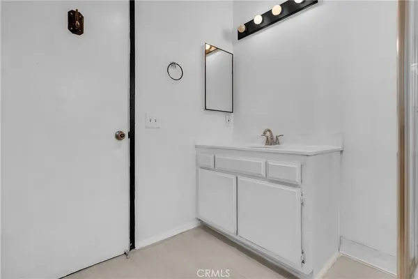 a bathroom with a sink a mirror and shower