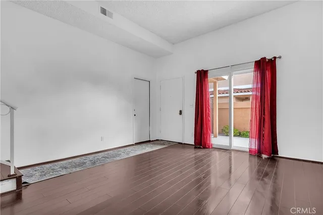 an empty room with wooden floor and closet