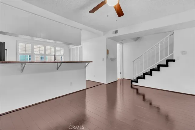 an empty room with windows and stairs