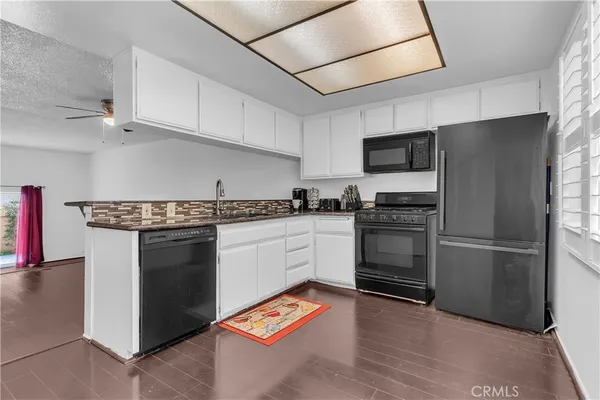 a kitchen with stainless steel appliances a refrigerator sink and microwave