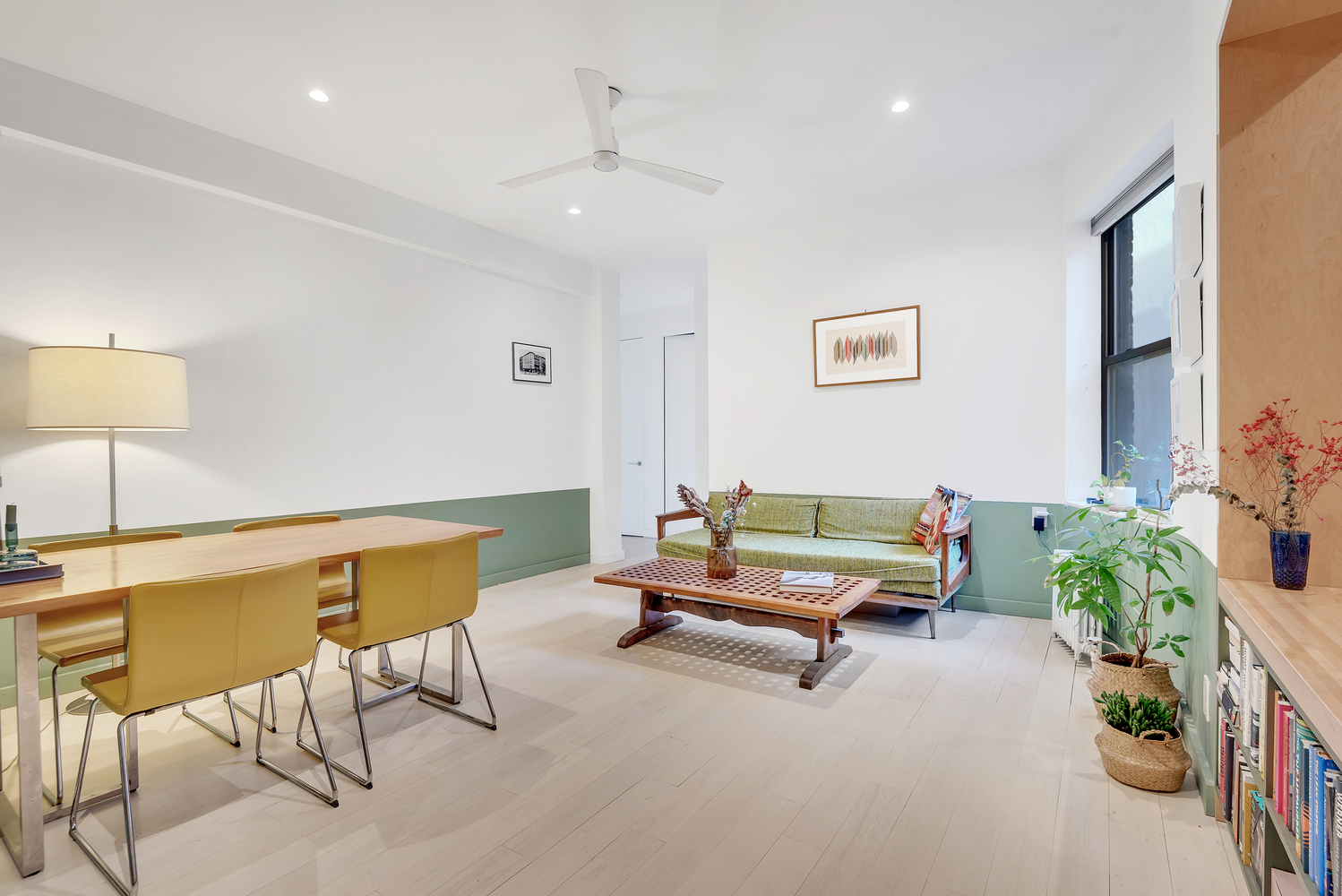 a living room with furniture and a potted plant