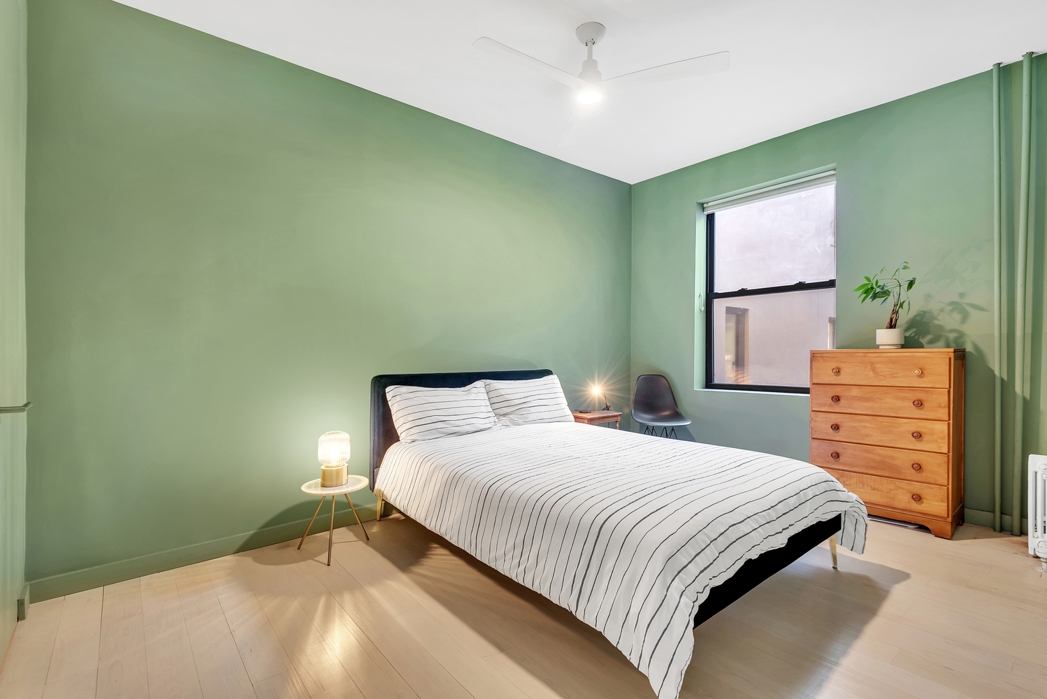 130 West 16th Street, Unit 51 Manhattan, NY 10011 - Photo 4 of 6 a bedroom with a bed and a dresser