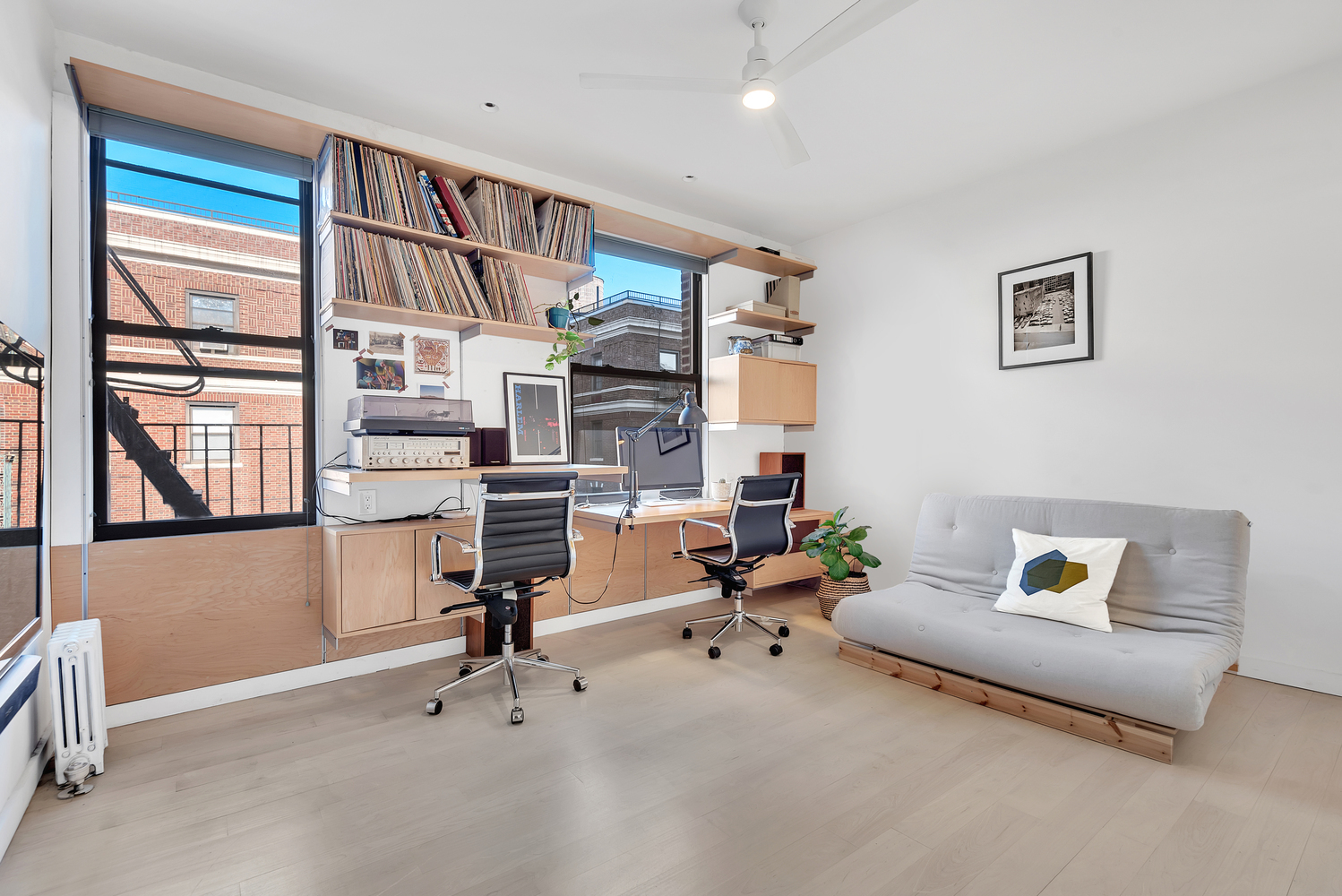 130 West 16th Street, Unit 51 Manhattan, NY 10011 - Photo 5 of 6 a view of a workspace with furniture and a window