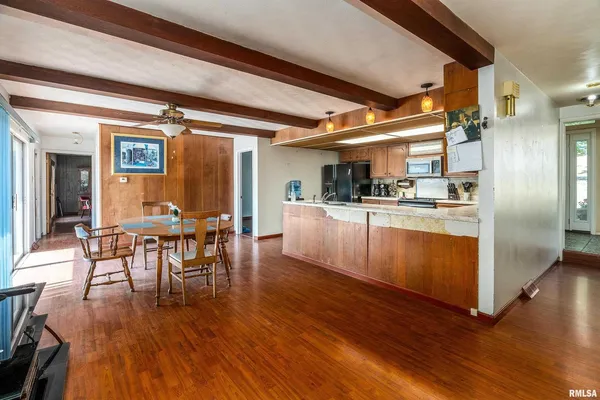 a dining room with wooden floors and a fireplace