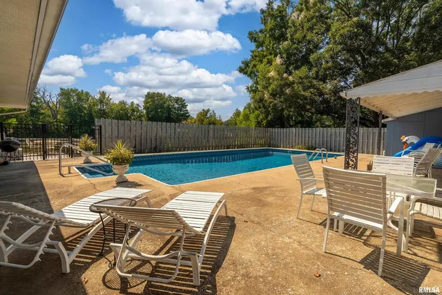 a view of a swimming pool with a patio