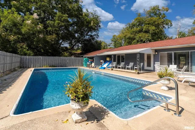 an aerial view of a house with a yard and lake view