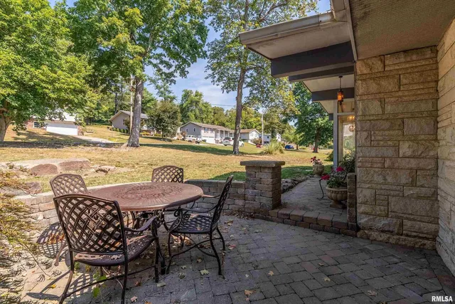 a view of a patio with table and chairs and potted plants