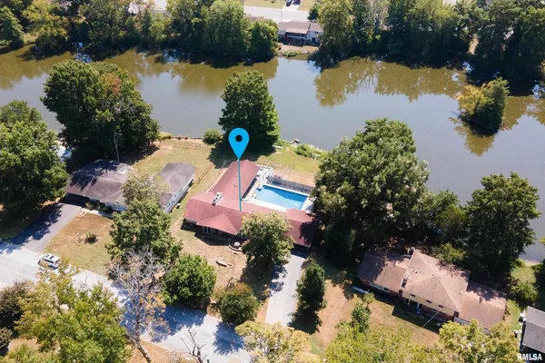 an aerial view of a house a yard and a garden