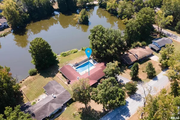 an aerial view of a house with a lake view