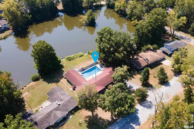 an aerial view of a house with a lake view