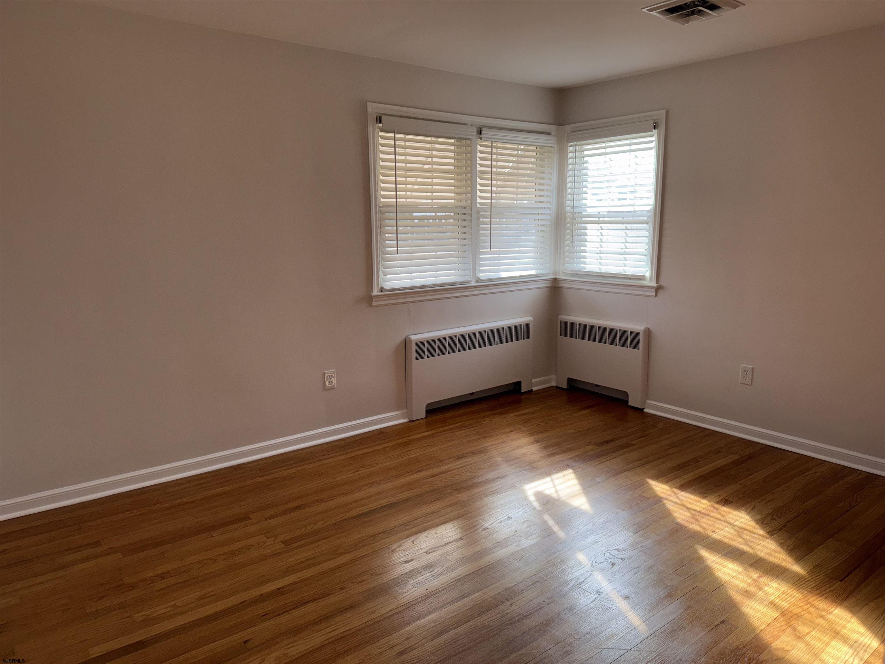 661 Grape Street Hammonton, NJ 08037 - Photo 11 of 14 an empty room with wooden floor and windows
