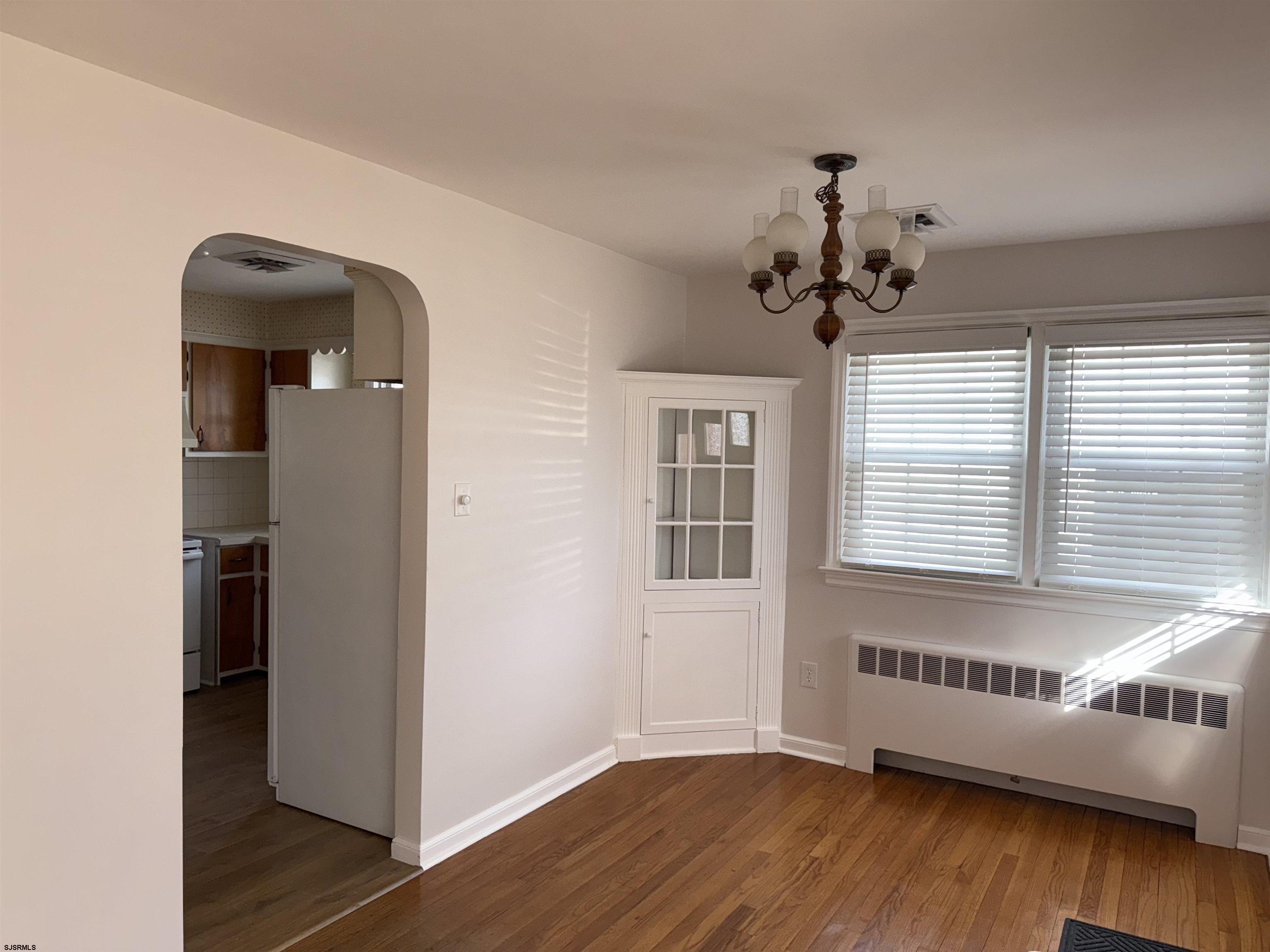 661 Grape Street Hammonton, NJ 08037 - Photo 2 of 14 a view of an empty room with wooden floor and a window