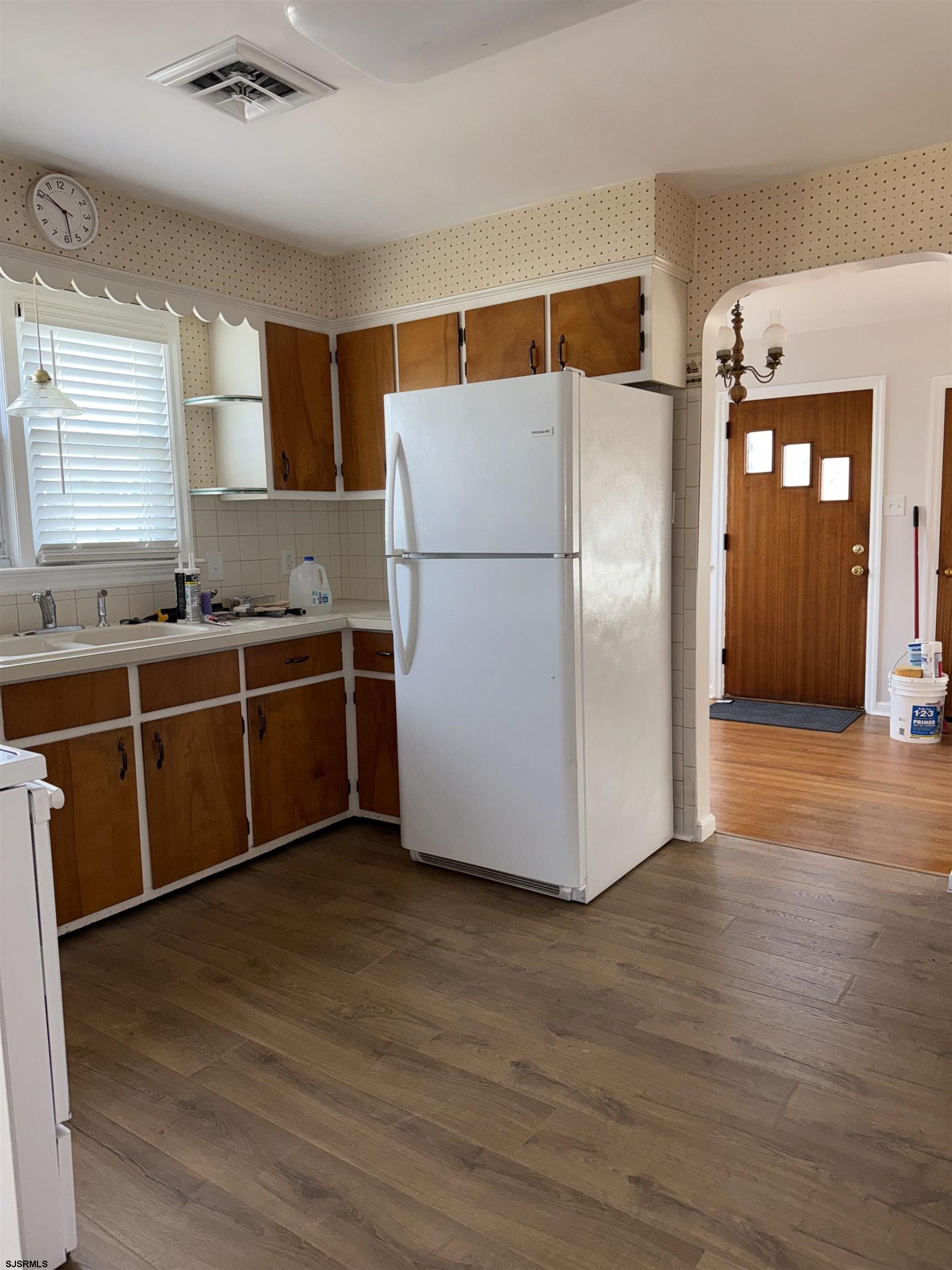 661 Grape Street Hammonton, NJ 08037 - Photo 4 of 14 a kitchen with stainless steel appliances a refrigerator and wooden floor