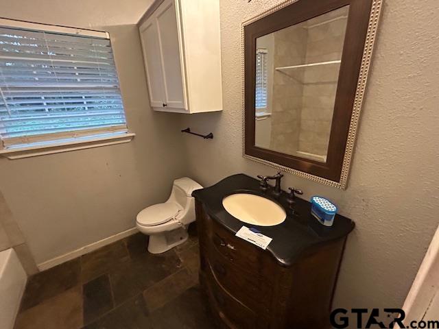983 Nandena Road Gilmer, TX 75644 - Photo 8 of 9 a bathroom with a toilet sink and mirror