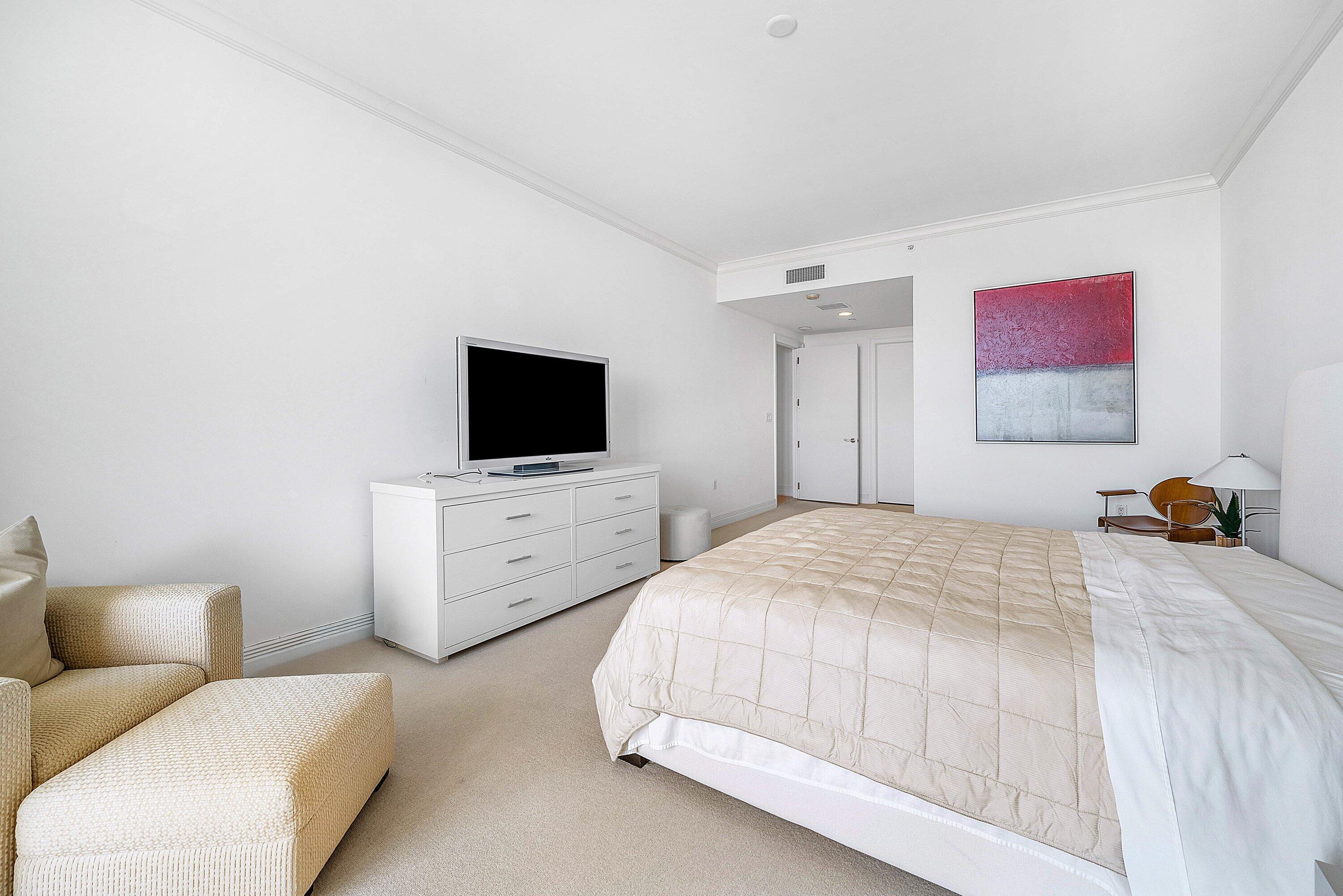 400 Southeast 5th Avenue, Unit 805N Boca Raton, FL 33432 - Photo 31 of 58 a bedroom with a bed and a flat screen tv