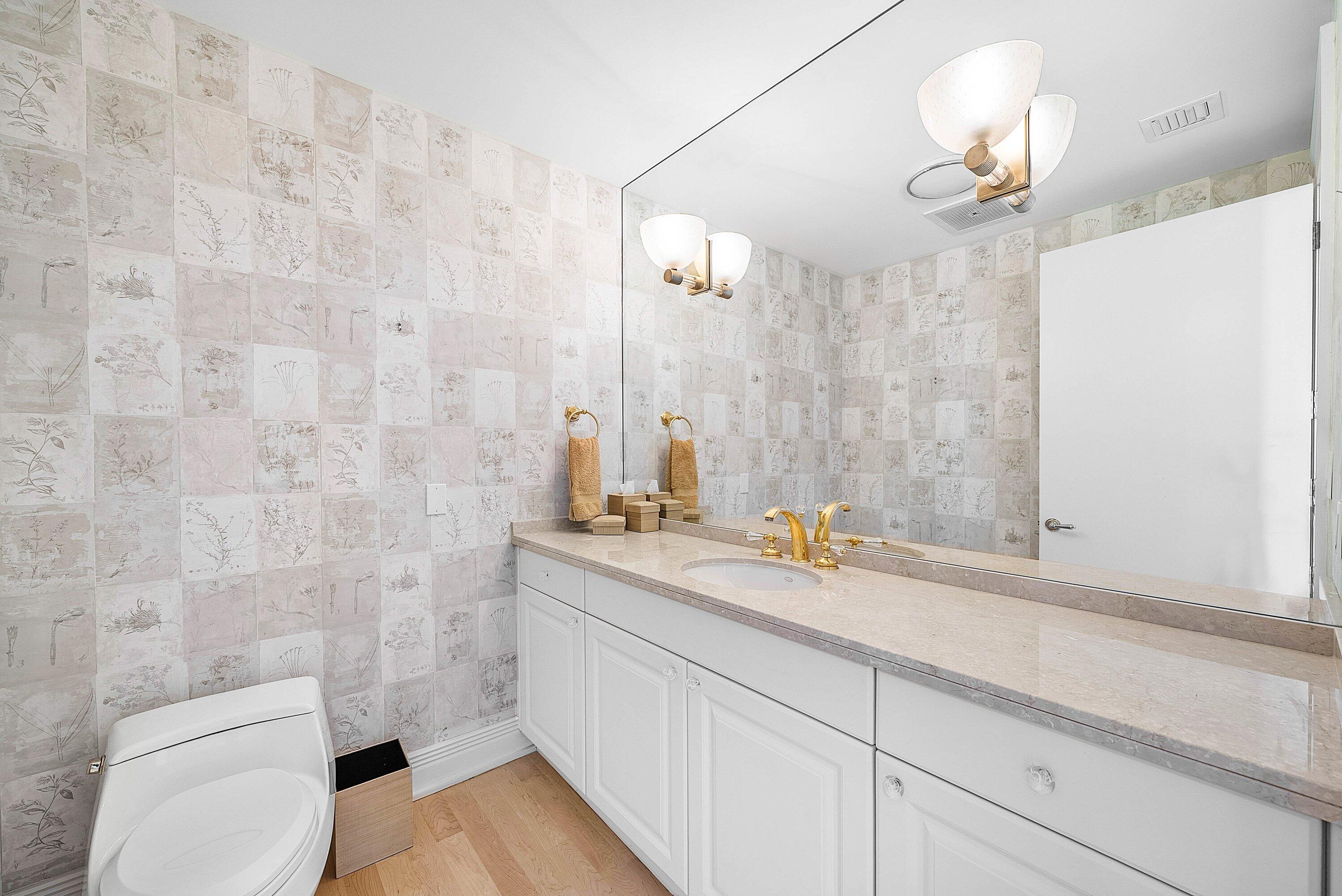 400 Southeast 5th Avenue, Unit 805N Boca Raton, FL 33432 - Photo 34 of 58 a bathroom with a toilet a sink and mirror