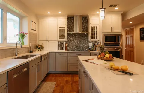 a kitchen with stainless steel appliances a sink stove and refrigerator