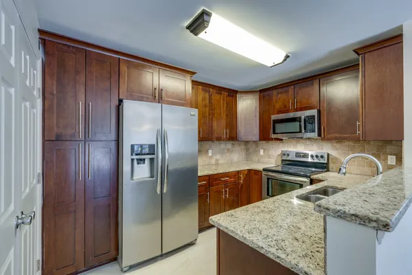 a kitchen with a sink stove and microwave