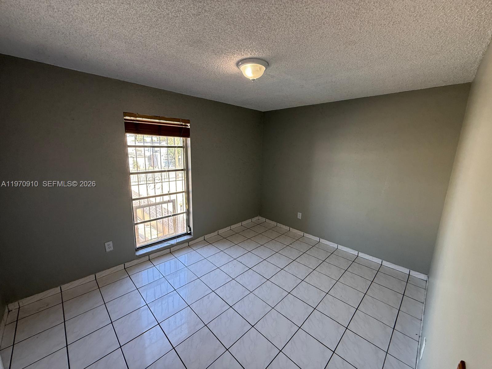 1051 Southwest 1st Street, Unit 207 Miami, FL 33130 - Photo 4 of 6 a view of an empty room and window