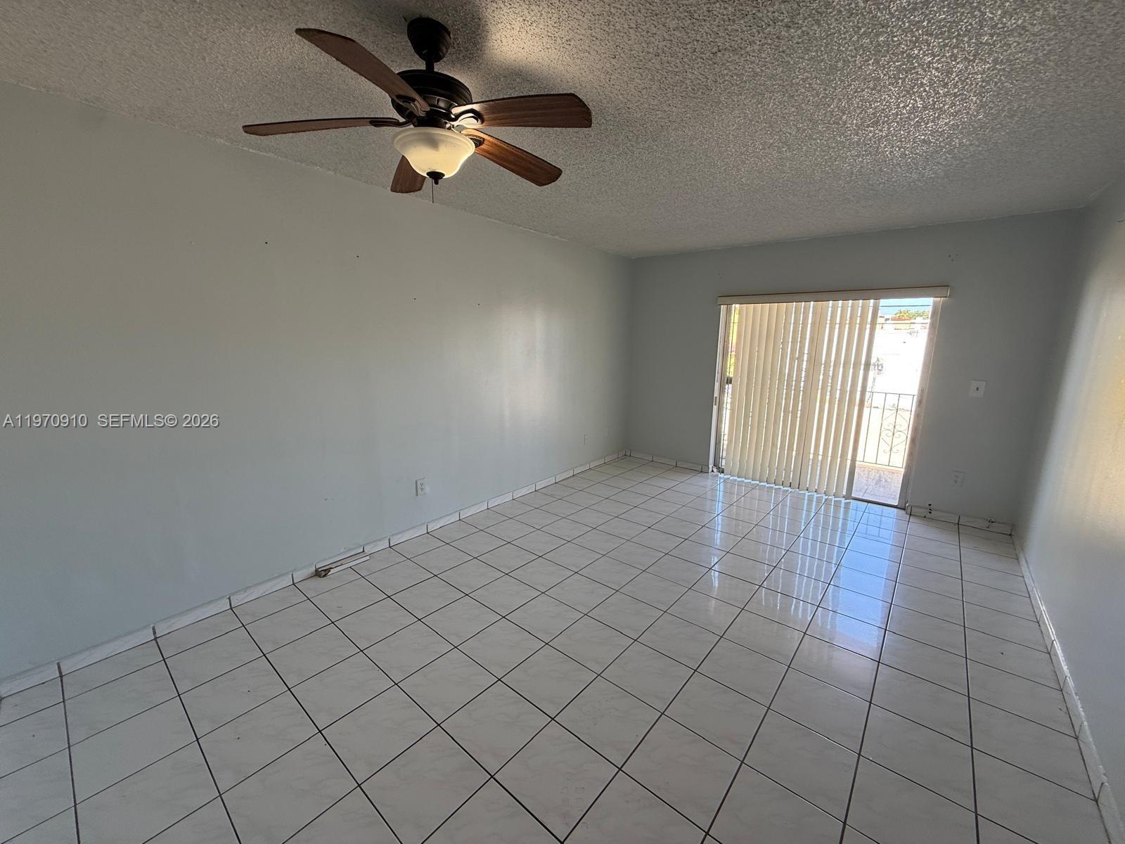 1051 Southwest 1st Street, Unit 207 Miami, FL 33130 - Photo 5 of 6 an empty room with windows and fan