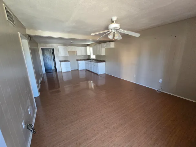 wooden floor in an empty room with a mirror