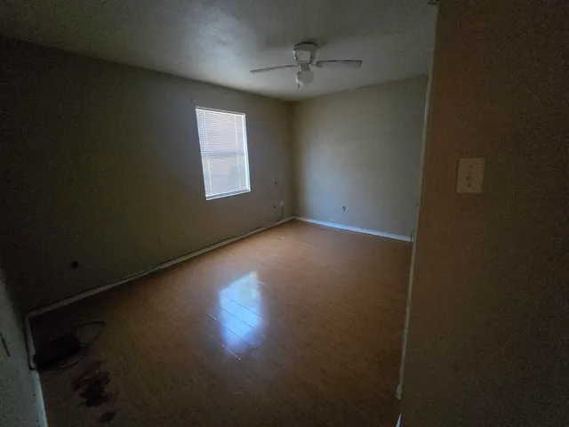 a view of room with window and hardwood floor