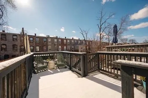 a view of a balcony with wooden floor