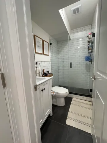 a bathroom with a toilet sink and shower