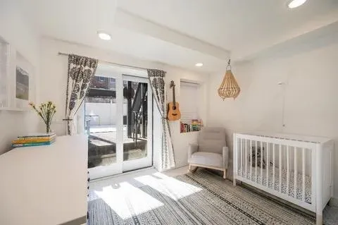 a living room with furniture potted plant and a wooden floor