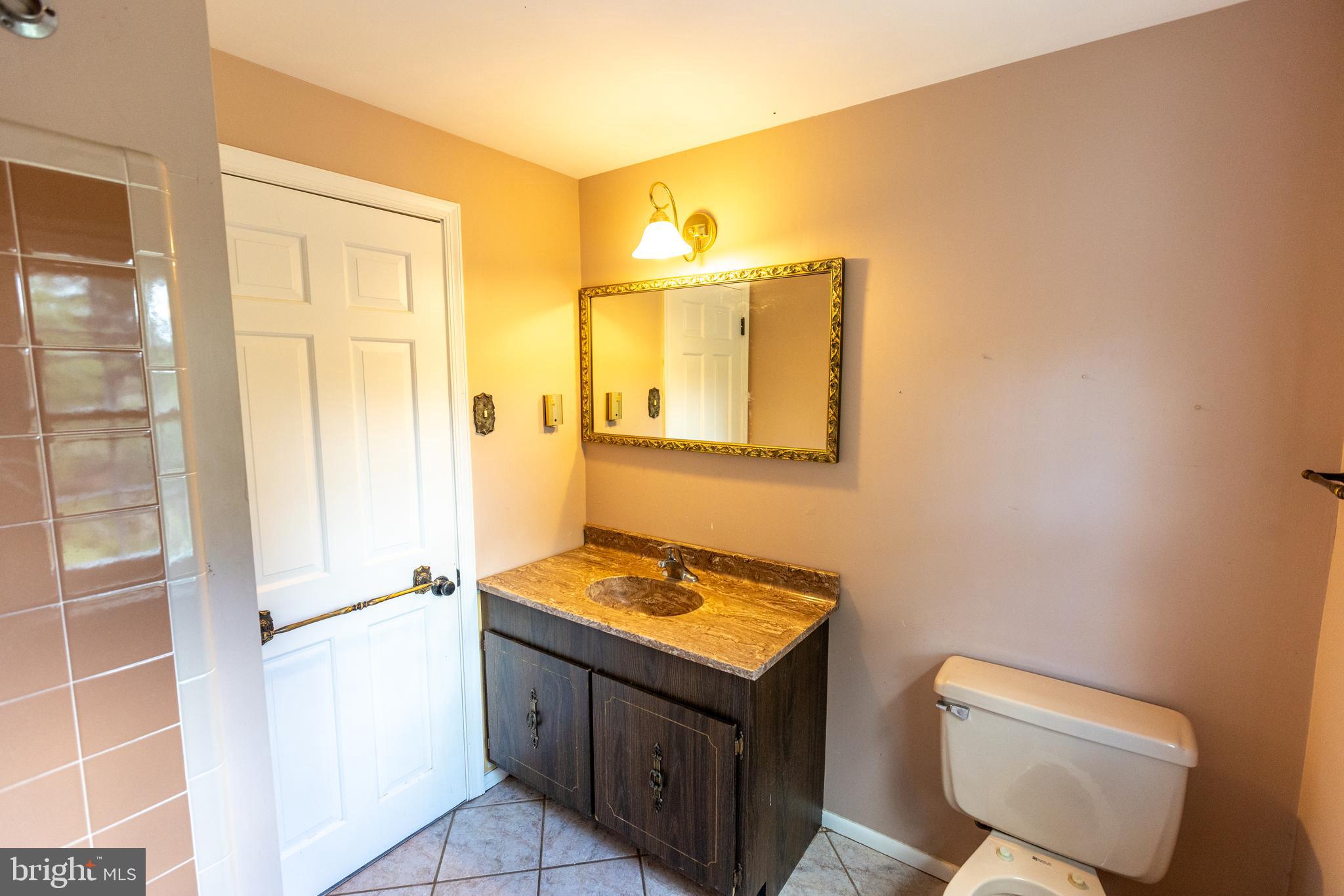 1929 Hillendale Road Chadds Ford, PA 19317 - Photo 43 of 56 a bathroom with a sink a toilet and shower