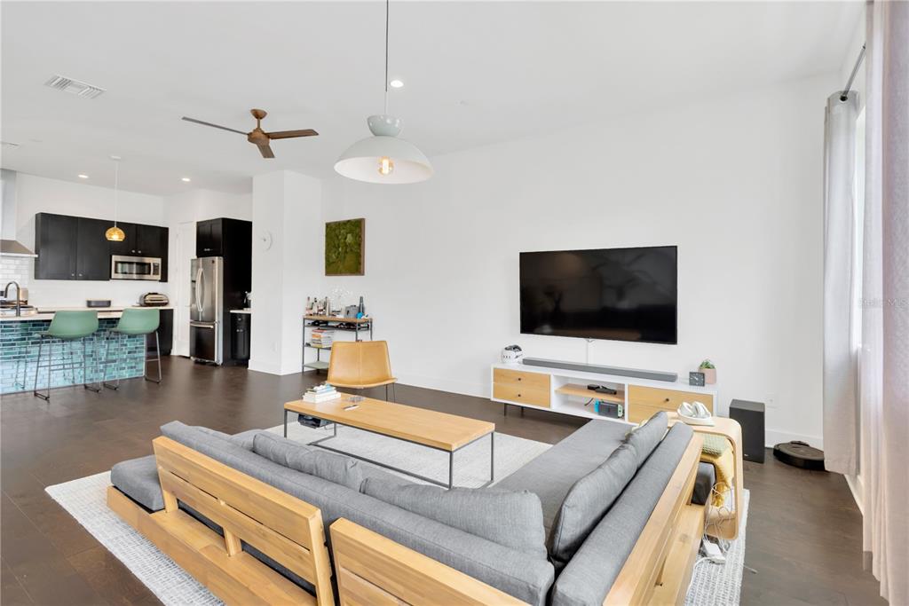 3100 West Paul Avenue, Unit 14 Tampa, FL 33611 - Photo 14 of 36 a living room with furniture and a flat screen tv