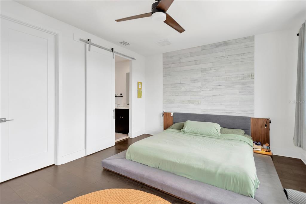 3100 West Paul Avenue, Unit 14 Tampa, FL 33611 - Photo 17 of 36 a bedroom with a bed closet and wooden floor