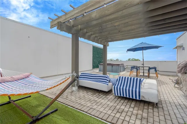 a view of a patio with wooden floor and furniture