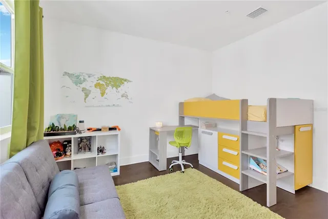 a living room with furniture and painting on the wall