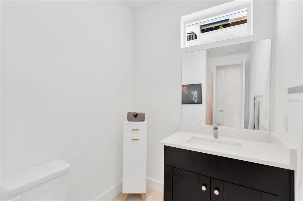 3100 West Paul Avenue, Unit 14 Tampa, FL 33611 - Photo 23 of 36 a bathroom with a sink a toilet and mirror