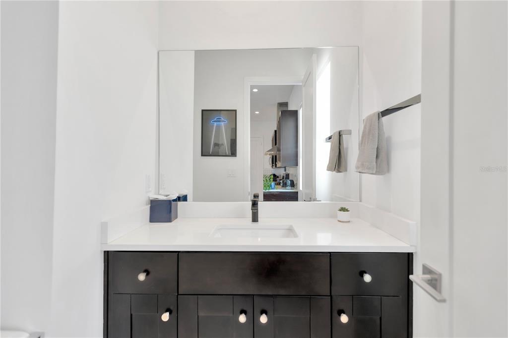 3100 West Paul Avenue, Unit 14 Tampa, FL 33611 - Photo 24 of 36 a bathroom with a sink and a mirror