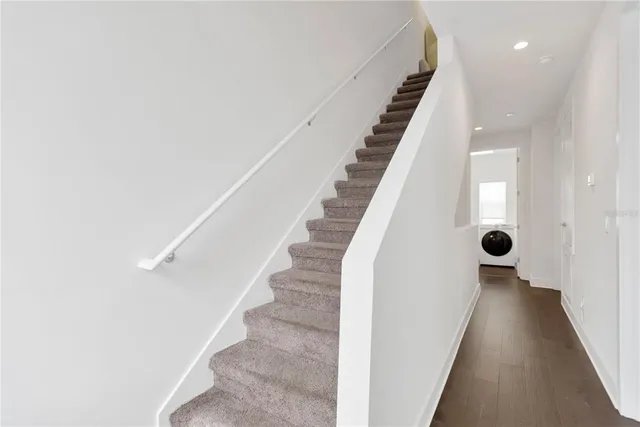 a view of entryway and hall with wooden floor