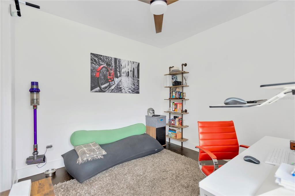 3100 West Paul Avenue, Unit 14 Tampa, FL 33611 - Photo 4 of 36 a living room with furniture and a wooden floor