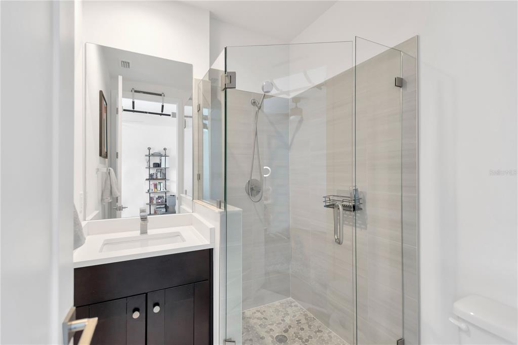 3100 West Paul Avenue, Unit 14 Tampa, FL 33611 - Photo 5 of 36 a bathroom with a shower sink and mirror